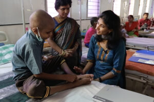 Hyderabad, Telangana, India Ñ 07 February 2018 Ñ Pediatric palliative care consultant Dr. Spandana Rayala with a young patient in the pediatric Ward at the Mehdi Nawaz Jung Institute and Regional Cancer Centre in Hyderabad. (Video still: Chuck Russell/TWCC)