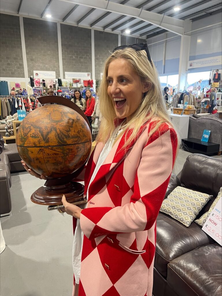 International Influencer 'Sophie Tea Art' Comes to Scotland for the FIRST time - to a hospice shop! Sophie Tea Art with globe at Strathcarron Hospice charity shop