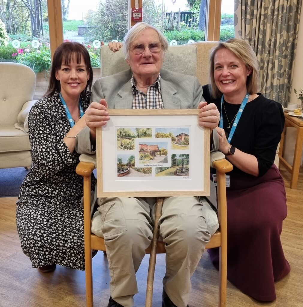Hospice founder unveils commissioned print to celebrate charity’s milestone Neil with Emma Radley and Steph Lawless